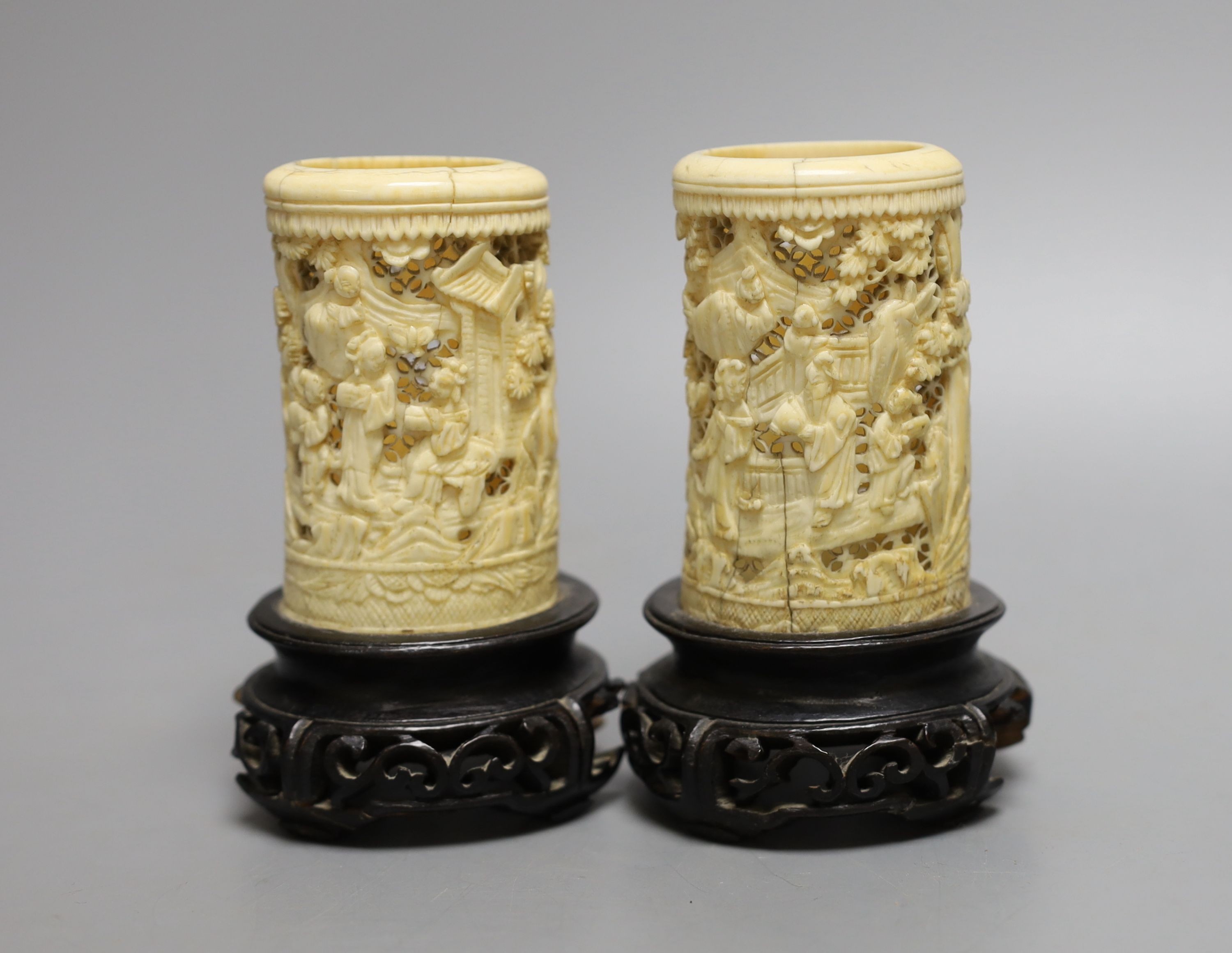 A pair of 19th century Chinese carved ivory brushpots on wooden stands - 12cm tall (including stands)